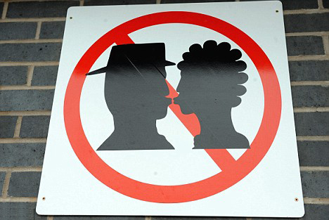 Man in Hat Kissing Woman Red Crossed Out Sign